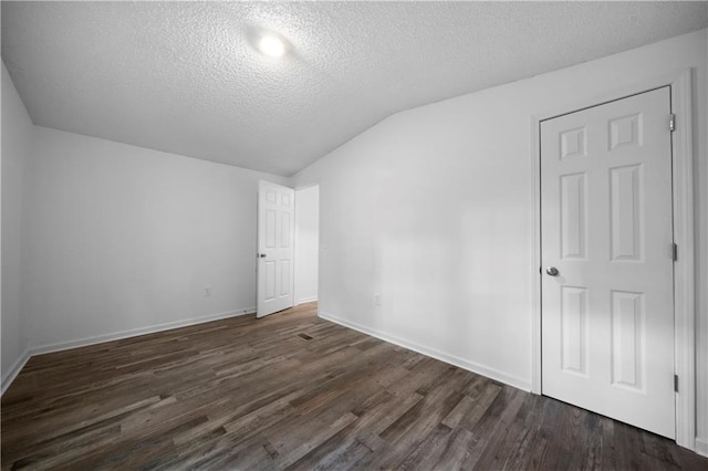 68 Wagon Trail Cir, Dallas, GA 30132 - additional living space featuring vaulted ceiling, a textured ceiling, and dark wood finished floors