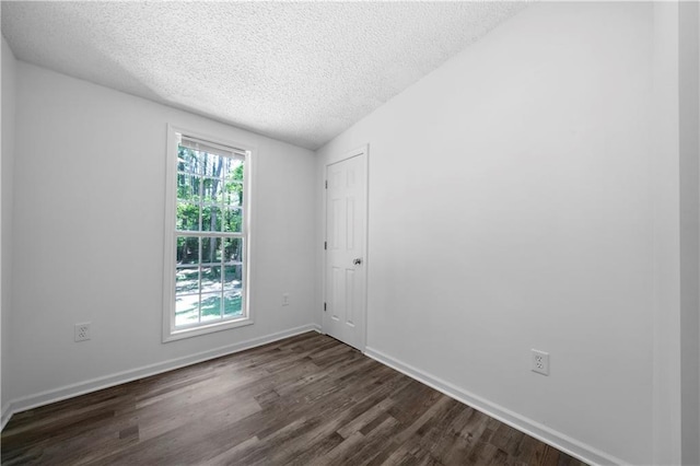 68 Wagon Trail Cir, Dallas, GA 30132 - spare room featuring a textured ceiling and dark wood finished floors