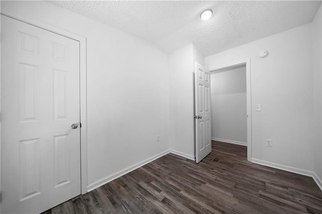68 Wagon Trail Cir, Dallas, GA 30132 - unfurnished bedroom with a textured ceiling and dark wood-style flooring