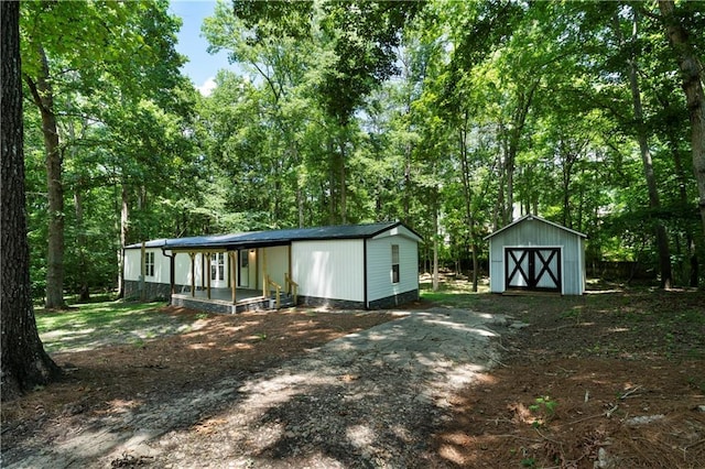 68 Wagon Trail Cir, Dallas, GA 30132 - back of property with a storage unit and covered porch