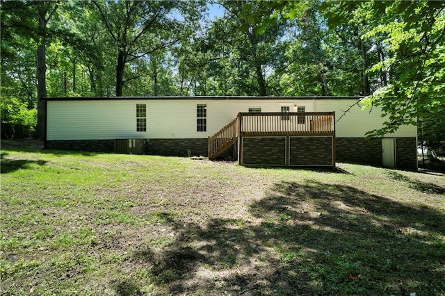 68 Wagon Trail Cir, Dallas, GA 30132 - view of front facade featuring a front yard, a deck, and stairs
