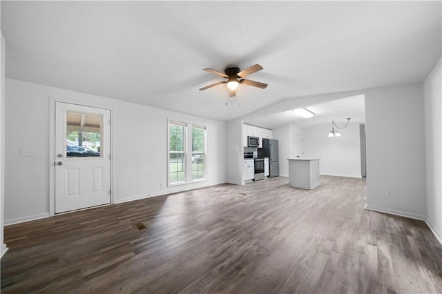 68 Wagon Trail Cir, Dallas, GA 30132 - unfurnished living room featuring healthy amount of natural light, ceiling fan, wood finished floors, a chandelier, and lofted ceiling