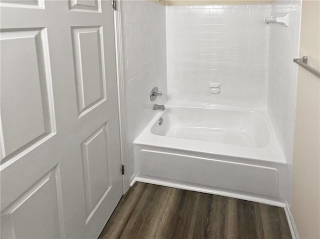 bathroom with hardwood / wood-style flooring and  shower combination