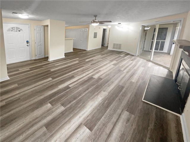 unfurnished living room featuring hardwood / wood-style flooring and ceiling fan