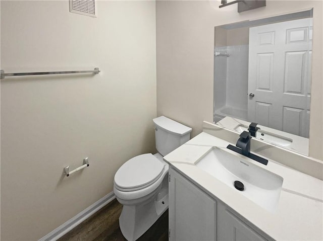 bathroom featuring toilet, hardwood / wood-style flooring, and vanity