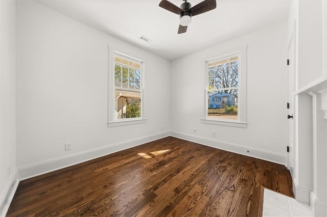 unfurnished bedroom with ceiling fan, dark wood-type flooring, visible vents, and baseboards