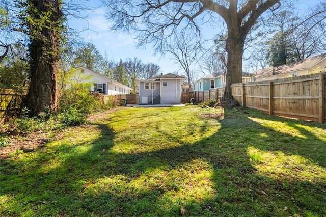 view of yard with a fenced backyard and a residential view