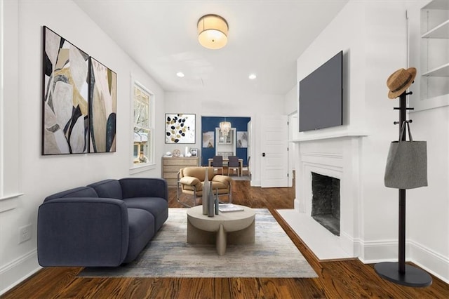 living room featuring dark wood-style flooring and baseboards