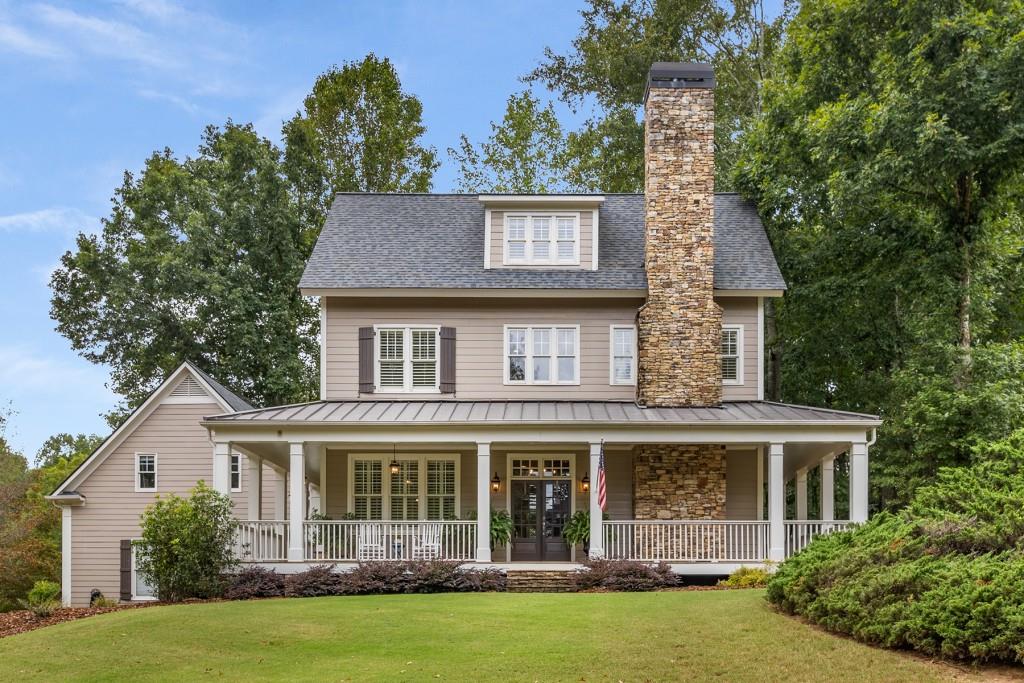 view of front of home with a front yard and covered porch