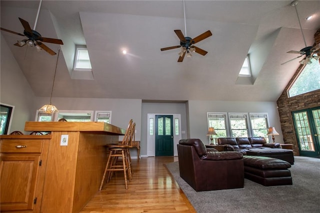1775 Whooping Creek Rd, Carrollton, GA 30116 - living area featuring high vaulted ceiling, ceiling fan, light wood-type flooring, and a bar