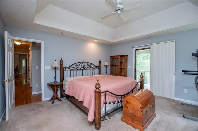 1775 Whooping Creek Rd, Carrollton, GA 30116 - carpeted bedroom featuring access to exterior, a raised ceiling, and ceiling fan