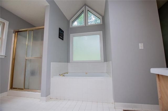 1775 Whooping Creek Rd, Carrollton, GA 30116 - bathroom with a shower stall, a bath, tile patterned floors, and lofted ceiling