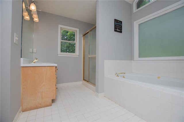 1775 Whooping Creek Rd, Carrollton, GA 30116 - full bath featuring vanity, a garden tub, a shower stall, and tile patterned floors