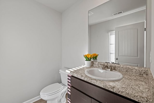 bathroom with vanity and toilet