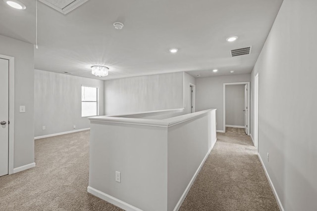 hallway with light colored carpet