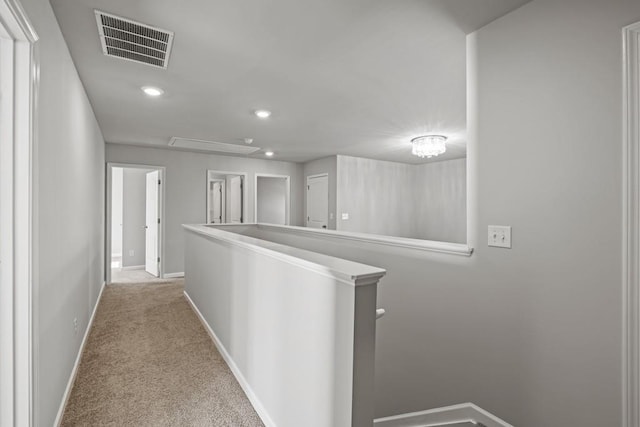 hallway with light colored carpet