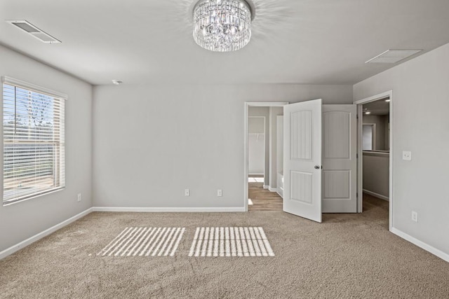 unfurnished bedroom with a chandelier and light carpet