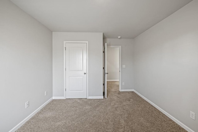 unfurnished bedroom featuring light colored carpet