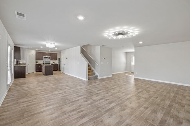 unfurnished living room featuring light hardwood / wood-style floors