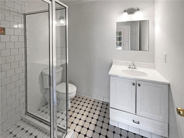 bathroom featuring vanity, walk in shower, and toilet