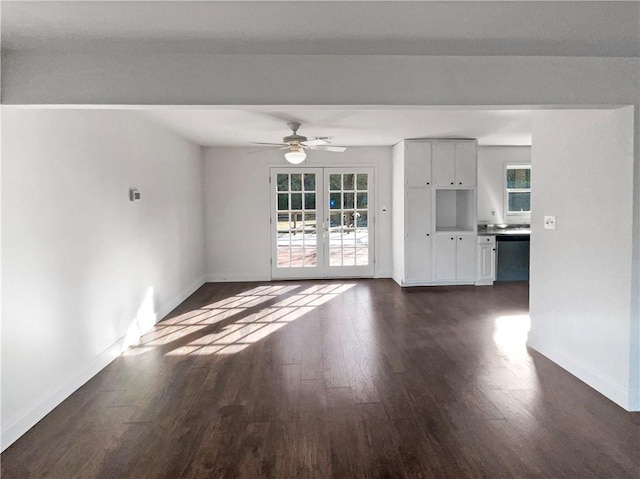 unfurnished living room featuring ceiling fan, dark hardwood / wood-style flooring, and french doors