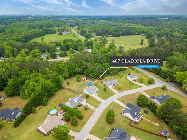 drone / aerial view with a wooded view
