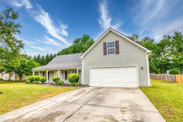 traditional home with a garage, fence, a front yard, and concrete driveway