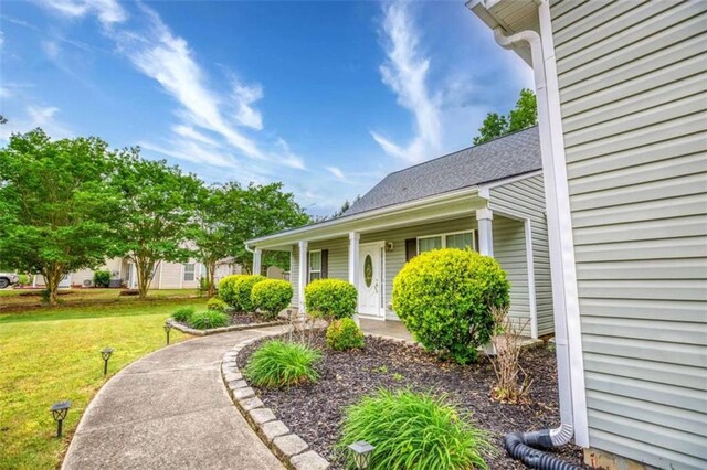 exterior space featuring a yard and covered porch