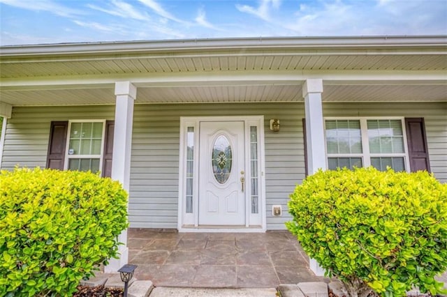 view of exterior entry featuring a porch