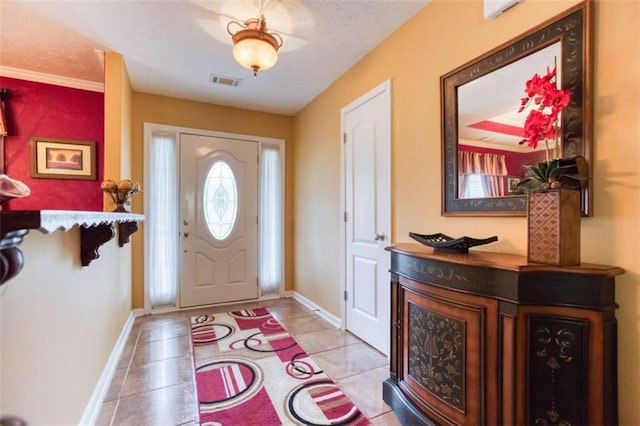 entryway featuring light tile patterned floors, visible vents, and baseboards