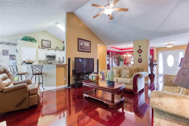 living room featuring lofted ceiling, wood finished floors, and a ceiling fan