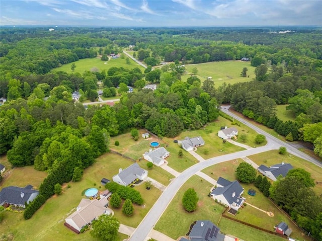 drone / aerial view with a residential view and a view of trees