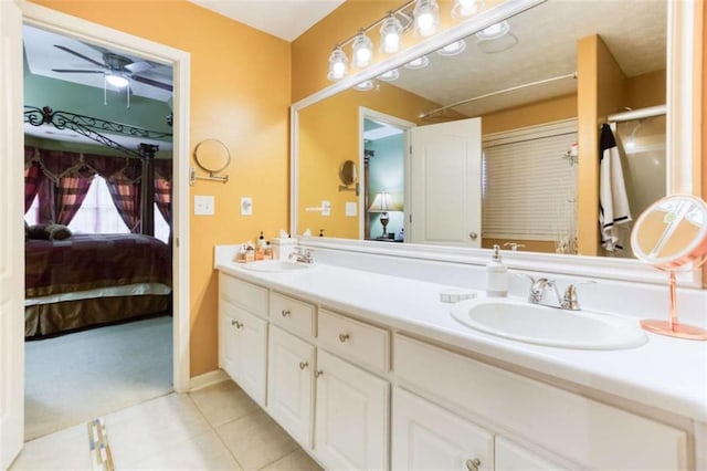 full bathroom featuring double vanity, ensuite bathroom, tile patterned flooring, and a sink