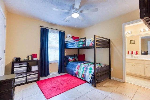 bedroom with tile patterned flooring, ceiling fan, and ensuite bathroom
