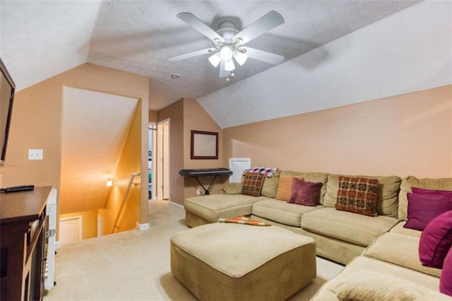 living room featuring a ceiling fan, light carpet, and lofted ceiling