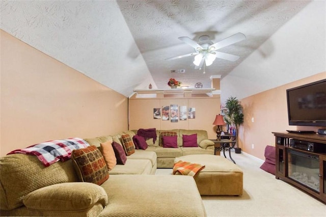 carpeted living room featuring a ceiling fan, visible vents, lofted ceiling, and a textured ceiling