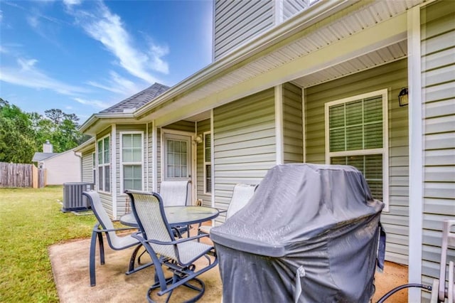 wooden deck with a yard, fence, central air condition unit, a patio, and outdoor dining area