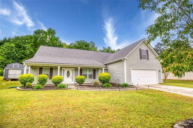 view of front of house with concrete driveway, a storage shed, a front yard, a porch, and a garage