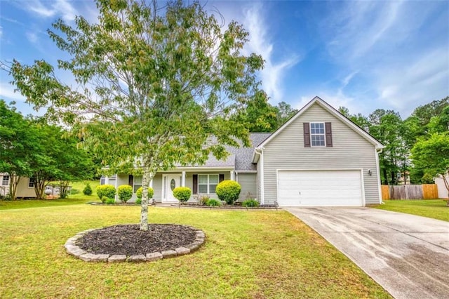 view of front of property with a front yard, driveway, an attached garage, and fence