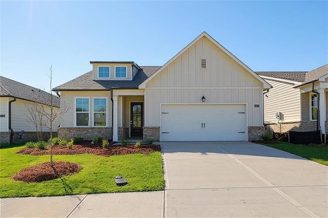 1682 Juniper Berry Way, Loganville, GA 30052 - craftsman-style house featuring board and batten siding, a garage, concrete driveway, brick siding, and a front yard