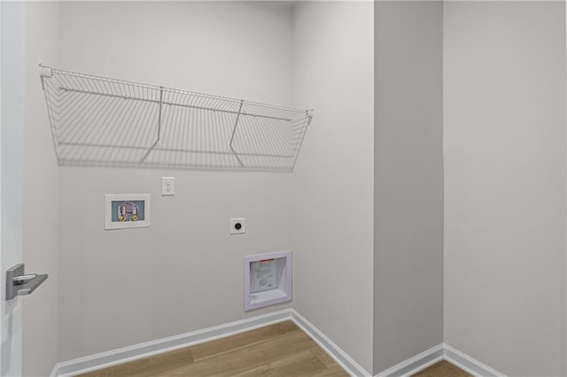 washroom with wood finished floors, electric dryer hookup, laundry area, hookup for a washing machine, and baseboards