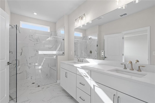 full bathroom with a marble finish shower, visible vents, marble finish floor, and a sink