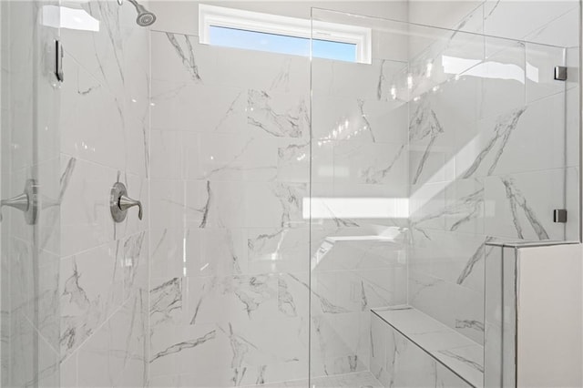 bathroom featuring a marble finish shower