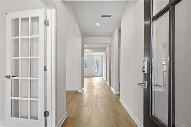 corridor with visible vents, wood finished floors, baseboards, and recessed lighting