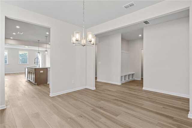 1682 Juniper Berry Way, Loganville, GA 30052 - spare room with light wood-type flooring, a chandelier, and recessed lighting