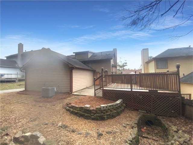 back of property with a wooden deck and central AC unit