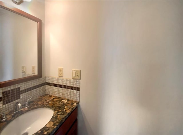 bathroom with vanity and decorative backsplash