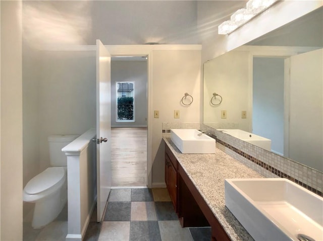 bathroom featuring vanity and toilet