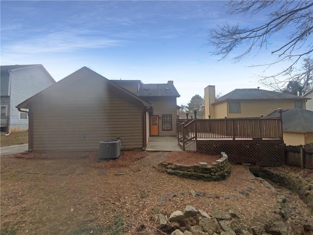 back of house with a patio area, a deck, and central air condition unit