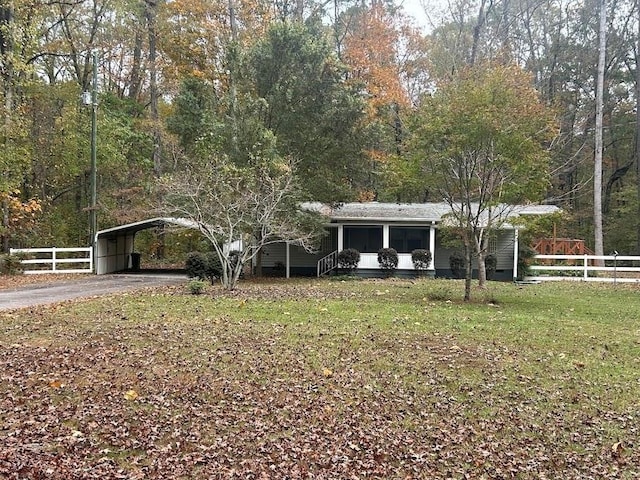 view of front of home with a front yard and a carport